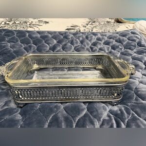 Vintage Fire King casserole dish with silver colored deco stand